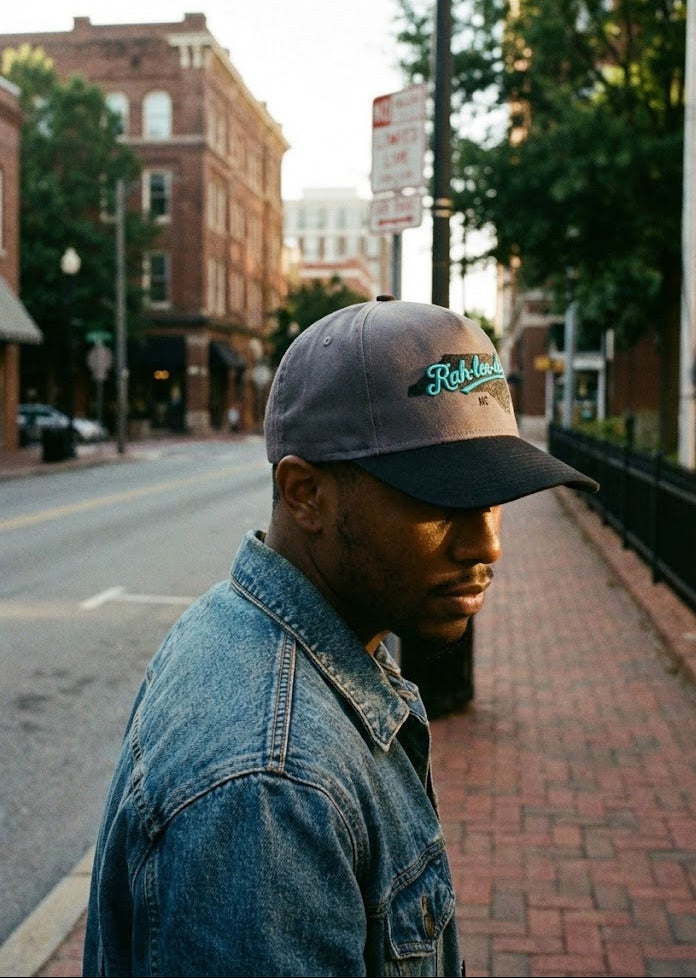 Man wearing a cap and denim jacket on Raleigh street