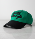 Green and black Well Sheeyit script dad hat with raised black embroidery